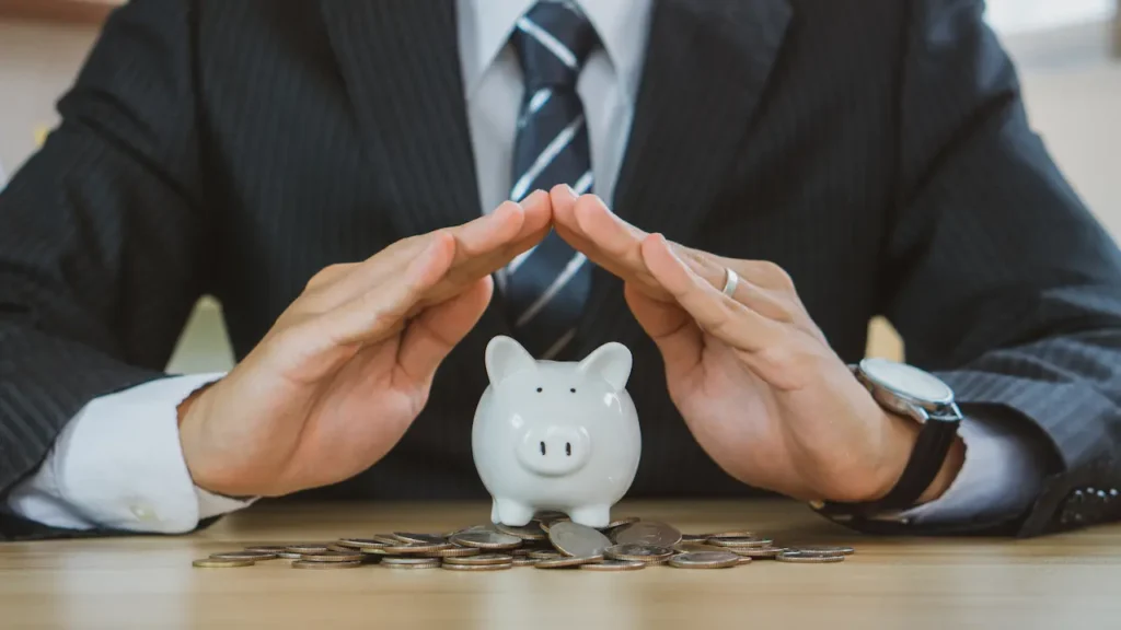 Businessman Protect The Piggybank 