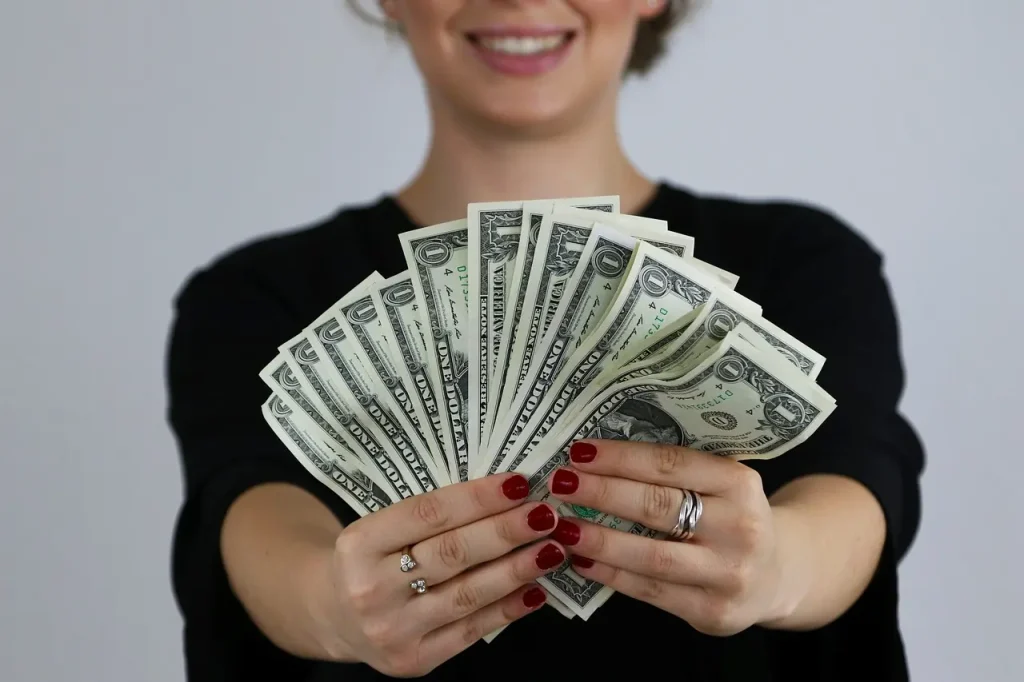 Woman Holding a Fan of Dollar Bills 