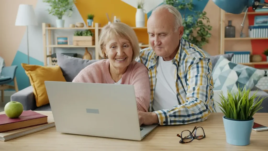 Elderly Couple Using a Laptop to Make a Plan for Retirement 