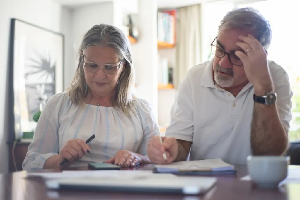 Retired Couple Calculating Their Expenses 