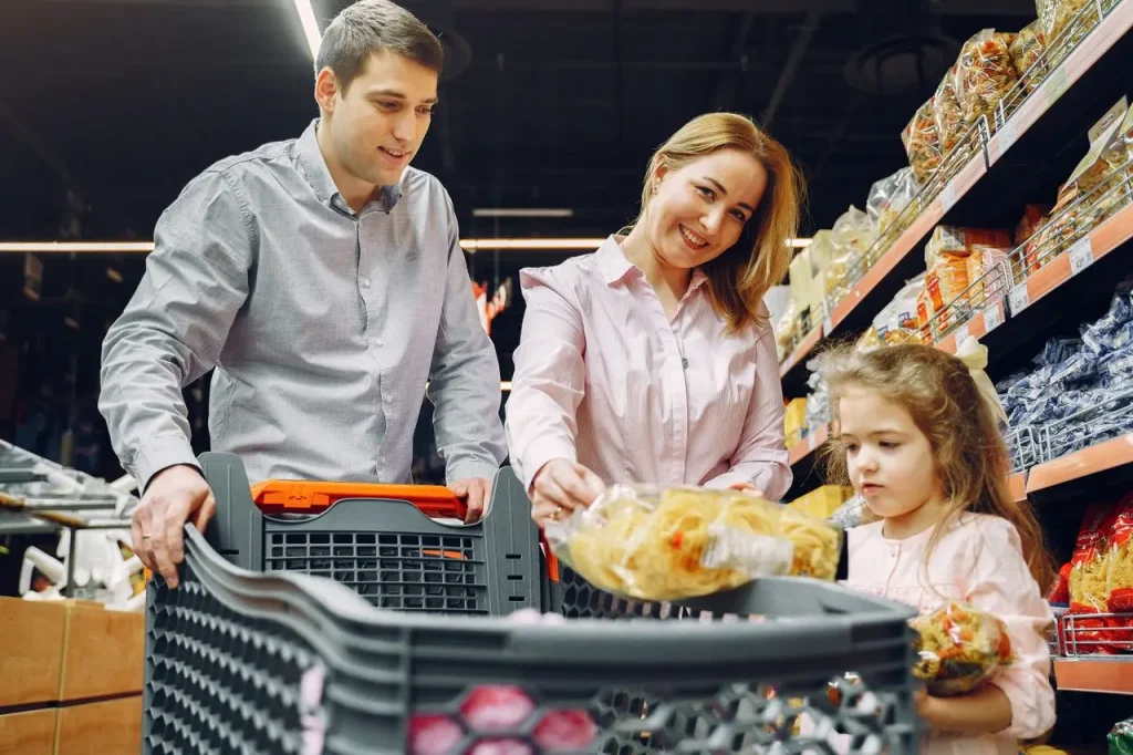 A Couple Shopping at a Supermarket with a Young Girl