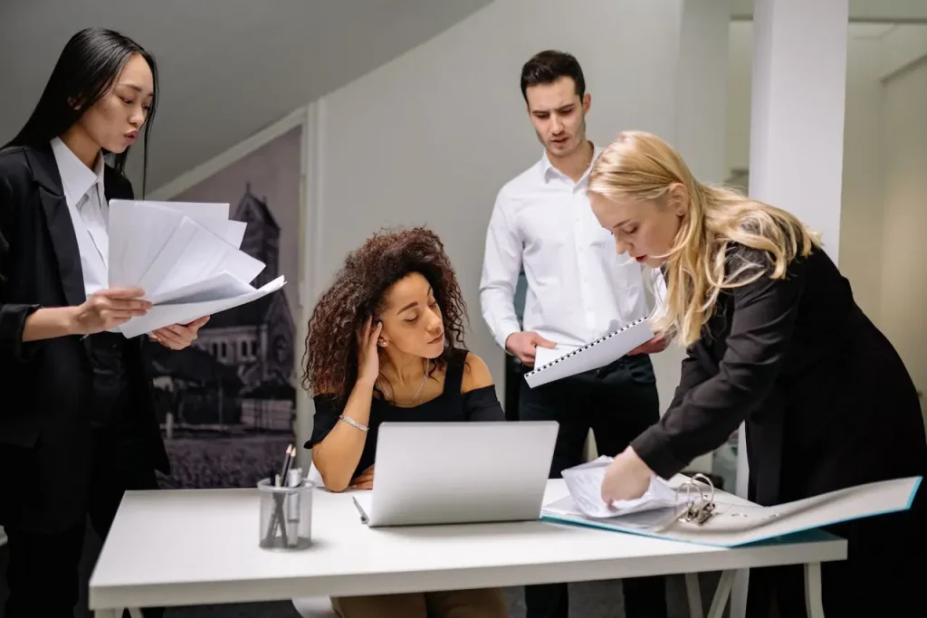 Coworkers Working Together on Paperwork and Solving Problems