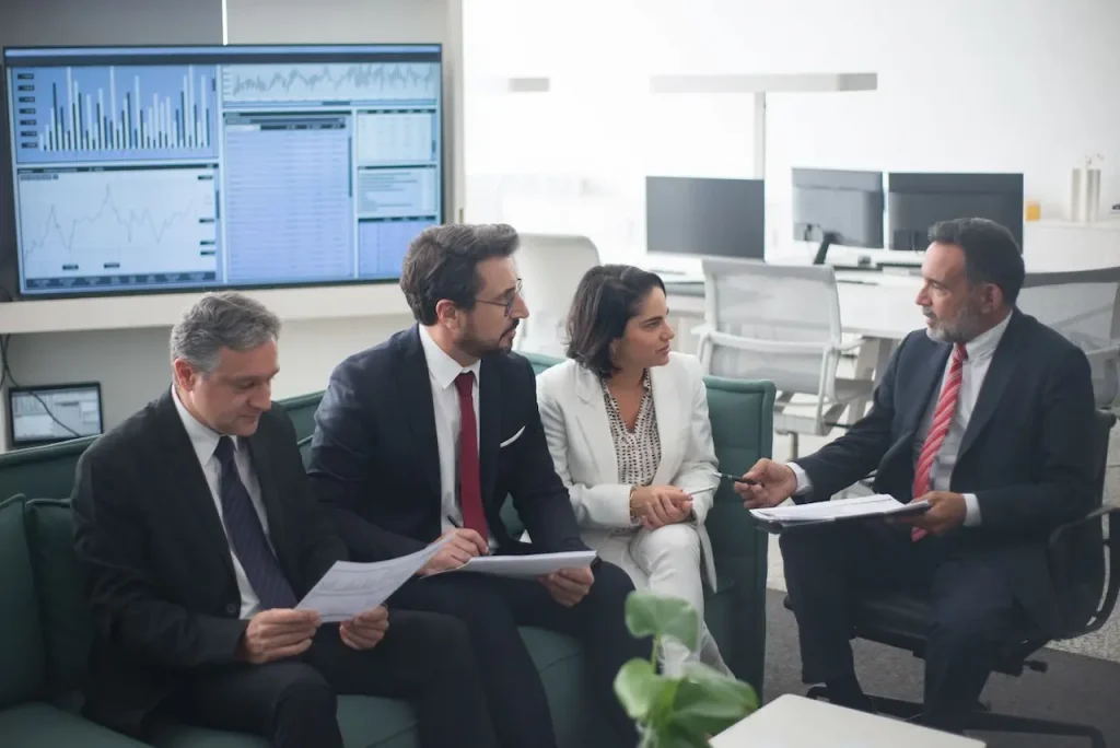 Four Business Professionals Discussing Financial Strategies 