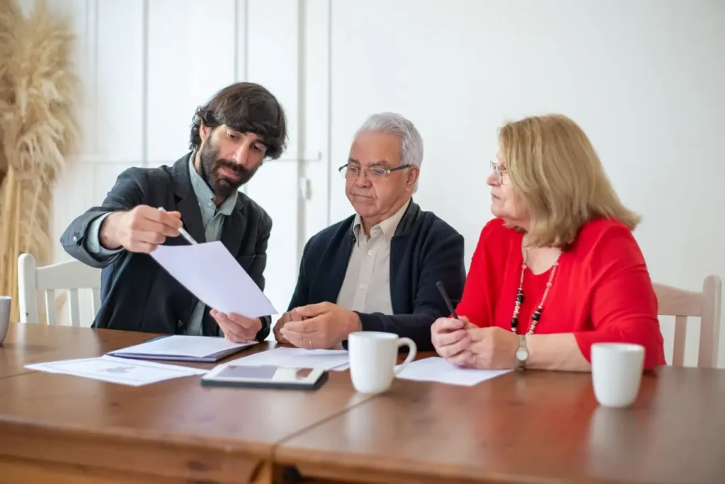 Elderly Couple Discussing Documents with Their Financial Advisor 